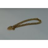 A 9ct gold curb chain bracelet having a padlock clasp