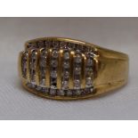 A gents diamond set signet ring having seven rows of channel set diamond chips flanked by two