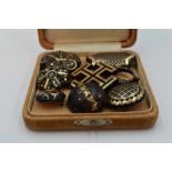 Eight Victorian tortoise shell brooches of various forms, all having pique decoration