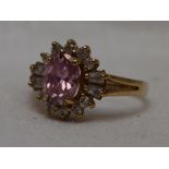 A lady's dress ring having having a pink gem and cubic zirconia cluster on a 9ct gold loop, size O