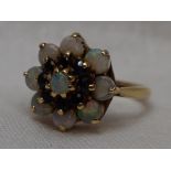 A lady's dress ring having a sapphire and opal triple cluster in a claw set basket mount on a 9ct