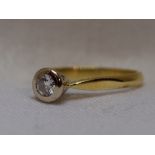 A lady's diamond solitaire dress ring, approx 0.25ct in a collared mount on an 18ct gold loop,