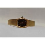 A lady's Zenith 9ct gold wrist watch having a baton numeral dial to a black hexagonal face on a