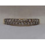 A lady's half eternity ring having a double row of diamond chips, total approx 0.5ct on an 18ct gold