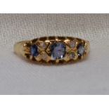 A lady's dress ring having three graduated powder blue sapphires interspersed by four small diamonds