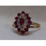 A lady's dress ring having a lozenge shaped ruby and diamond chip triple cluster in a claw set mount