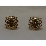 A pair of 9ct gold stud earrings having pierced square panels