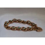 A Victorian rose gold and opal bracelet stamped 9ct having thirteen oval links having central