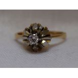 A lady's dress ring having a diamond solitaire, approx 0.128ct in a stylised white and yellow