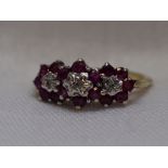 A lady's dress ring having a trio of ruby and diamond clusters on a 9ct gold loop, size K/L