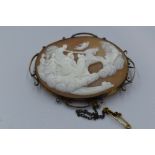 A large conche shell cameo brooch depicting Aurora the goddess of dawn on her chariot in a yellow