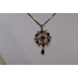 An Edwardian style 9ct gold pendant having central sapphire and diamond cluster in a diamond and