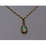 An opal pendant of teardop form in a yellow metal mount on chain stamped 375, approx 16"