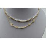 A cultured pearl necklace having yellow metal bead spacers and a 9ct gold clasp and a seed pearl