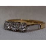 A lady's dress ring having a trilogy of diamonds, total approx 0.15ct in claw set mount to