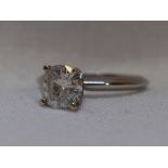 A lady's diamond solitaire dress ring, approx 1.1ct in a 4 claw raised mount on a white metal loop