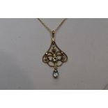 An Edwardian style 9ct gold pendant having seed pearl and aqua marine decoration on an 18ct gold