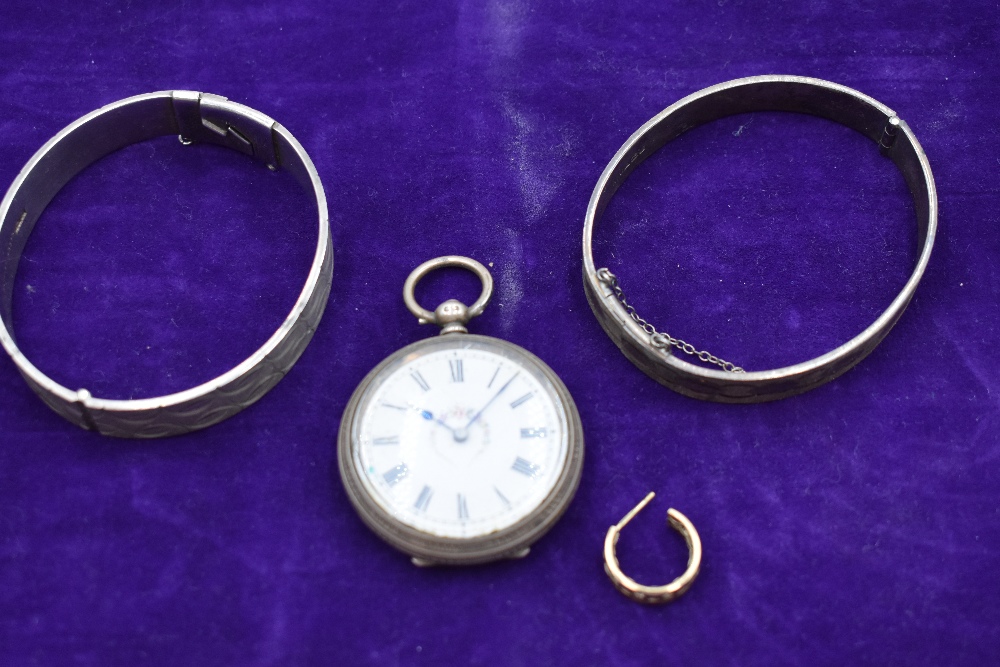 Two HM silver hinged bangles having engraved decoration, a small HM silver key wound pocket watch