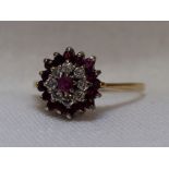 A lady's dress ring having a diamond and garnet triple cluster on a 9ct gold loop, size N