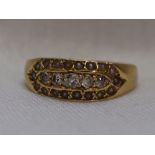 A Victorian lady's band ring having a central line of five graduated diamonds, approx 0.2ct within a