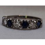 A lady's half eternity ring having four sapphires interspersed by three diamonds, total approx 1ct &