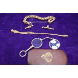 A small selection of yellow metal jewellery including watch keys, chain and a folding pince nez