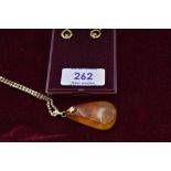 A Baltic amber style pendant on a yellow metal decorative chain, stamped 9K and a pair of 9ct gold