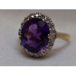 A lady's dress ring having a heat treated amethyst and diamond chip cluster in a claw set stepped