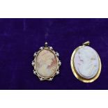 A conche shell cameo pendant depicting a Grecian maiden in a plain yellow metal mount stamped 9ct,