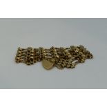 A 9ct gold four bar gate bracelet of broad twist form with padlock clasp