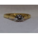 A lady's diamond solitaire dress ring, approx 0.25ct in a claw set raised mount to shaped