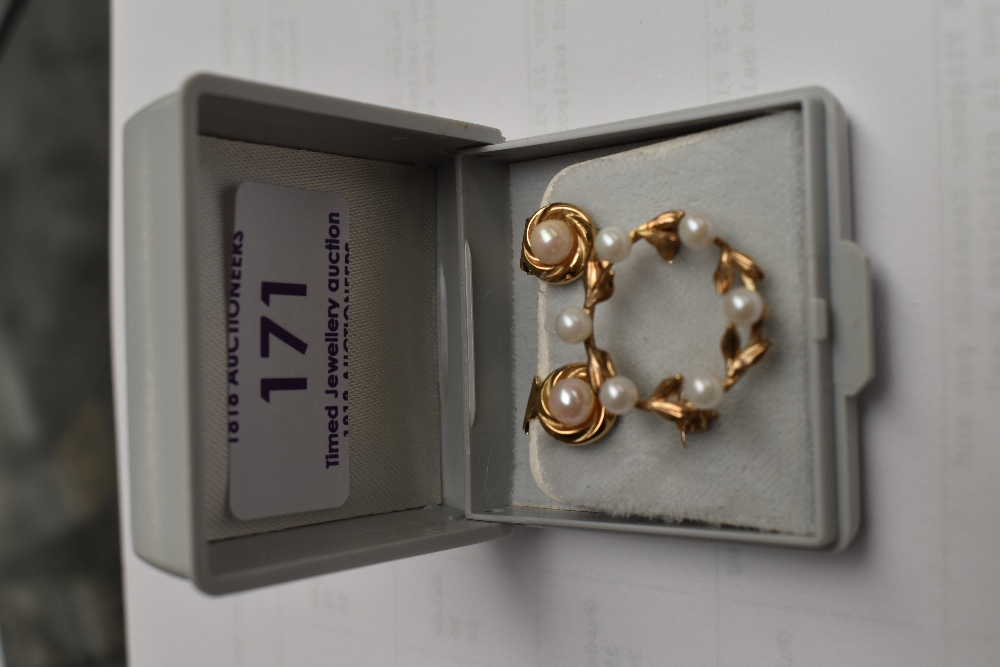 A pair of cultured pearl clip earrings in 9ct gold mounts and a small 9ct gold wreath brooch