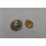 A jasperware style cameo brooch depicting a maiden in profile in a 9ct gold decorative mount and a