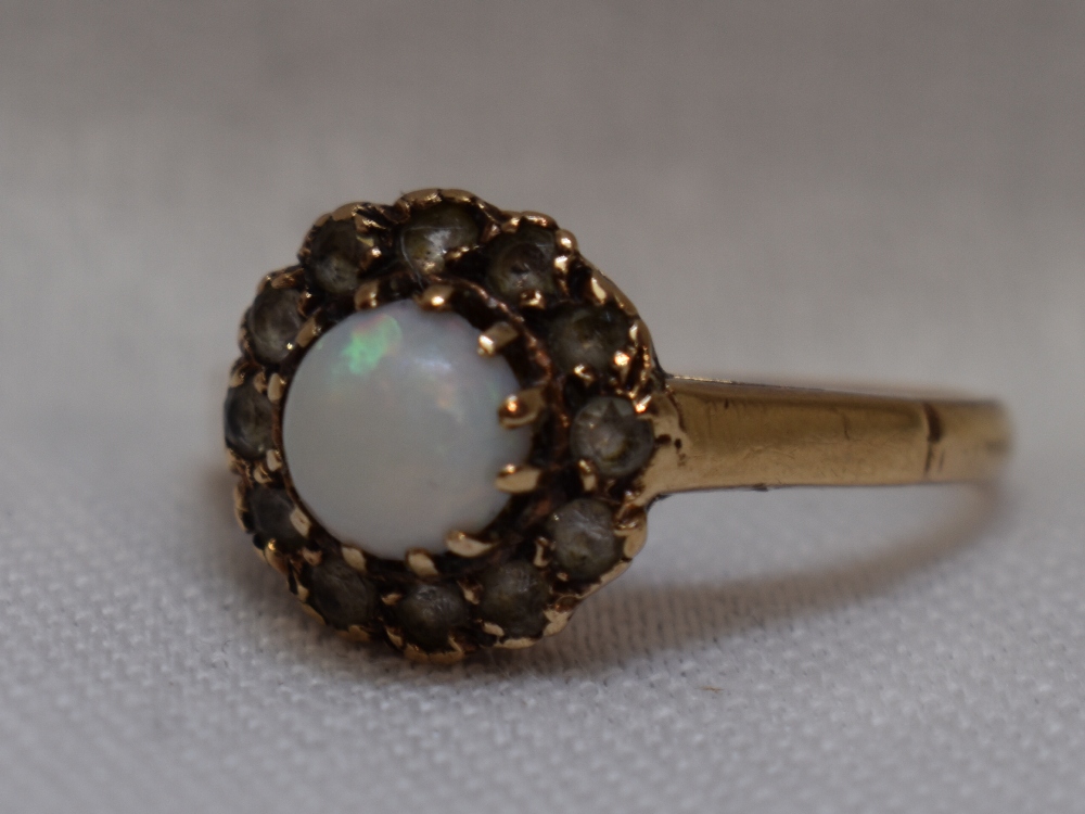 A lady's dress ring having an opal and cubic zirconia cluster on a 9ct gold loop, size N