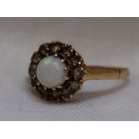 A lady's dress ring having an opal and cubic zirconia cluster on a 9ct gold loop, size N