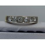 A lady's half eternity ring having six diamonds, total approx 0.38ct in pave mounted channel setting