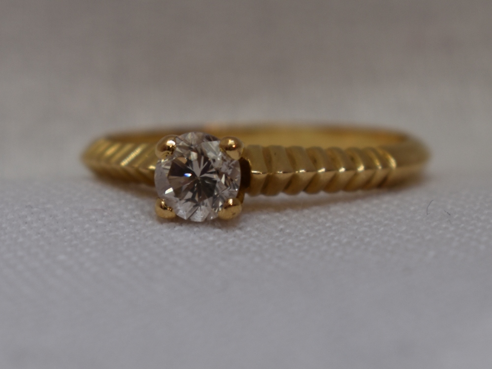 A lady's dress ring having a diamond solitaire, approx 0.40ct in a four claw raised setting to