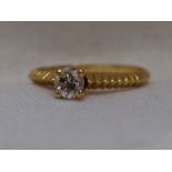 A lady's dress ring having a diamond solitaire, approx 0.40ct in a four claw raised setting to