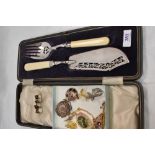 A cased set of fish servers having HM silver collars and a small selection of brooches and collar