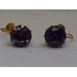 A pair of amethyst screw back yellow metal earrings stamped 9ct