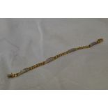A yellow metal bracelet stamped 750 having four diamond set panels, total approx 1.5ct, with curb