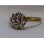 A lady's dress ring having a diamond cluster, total approx 0.04ct in a claw set mount on a yellow