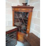 An Edwardian mahogany corner full height display cabinet having astral glazed top with cupboard base