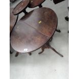 A 19th century oak pedestal table having circular top on turned column and triple splay legs,