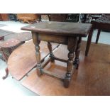 A 20th Century oak joint/coffin stool in the distressed 18th Century style having rectangular top