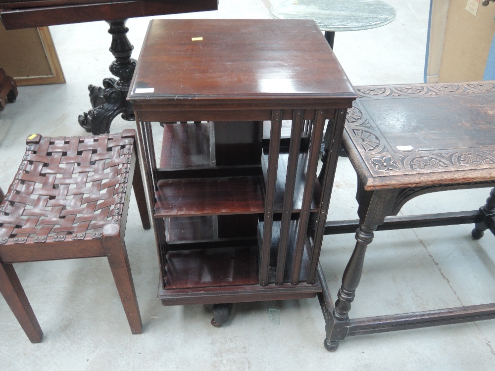 An early 20th Century revolving bookcase having slat sections on base, width approx. 48cm