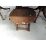 A mid 20th Century golden oak coffee table of Jacobean influence having circular top and turned