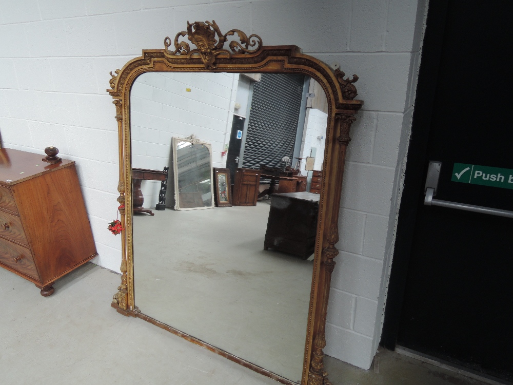 A 19th century gilt plaster overmantel mirror having pillar and scroll crest frame, approx