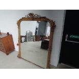 A 19th century gilt plaster overmantel mirror having pillar and scroll crest frame, approx