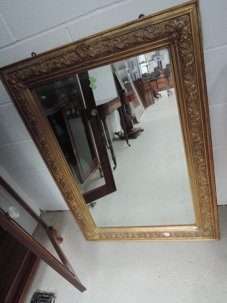 A 19th century gilt plaster frame rectangular wall mirror having swivel decoration, approx